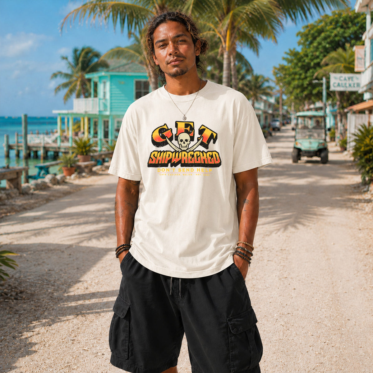 Model wearing the ivory Get Shipwrecked Rocker Tee with orange and yellow pirate artwork