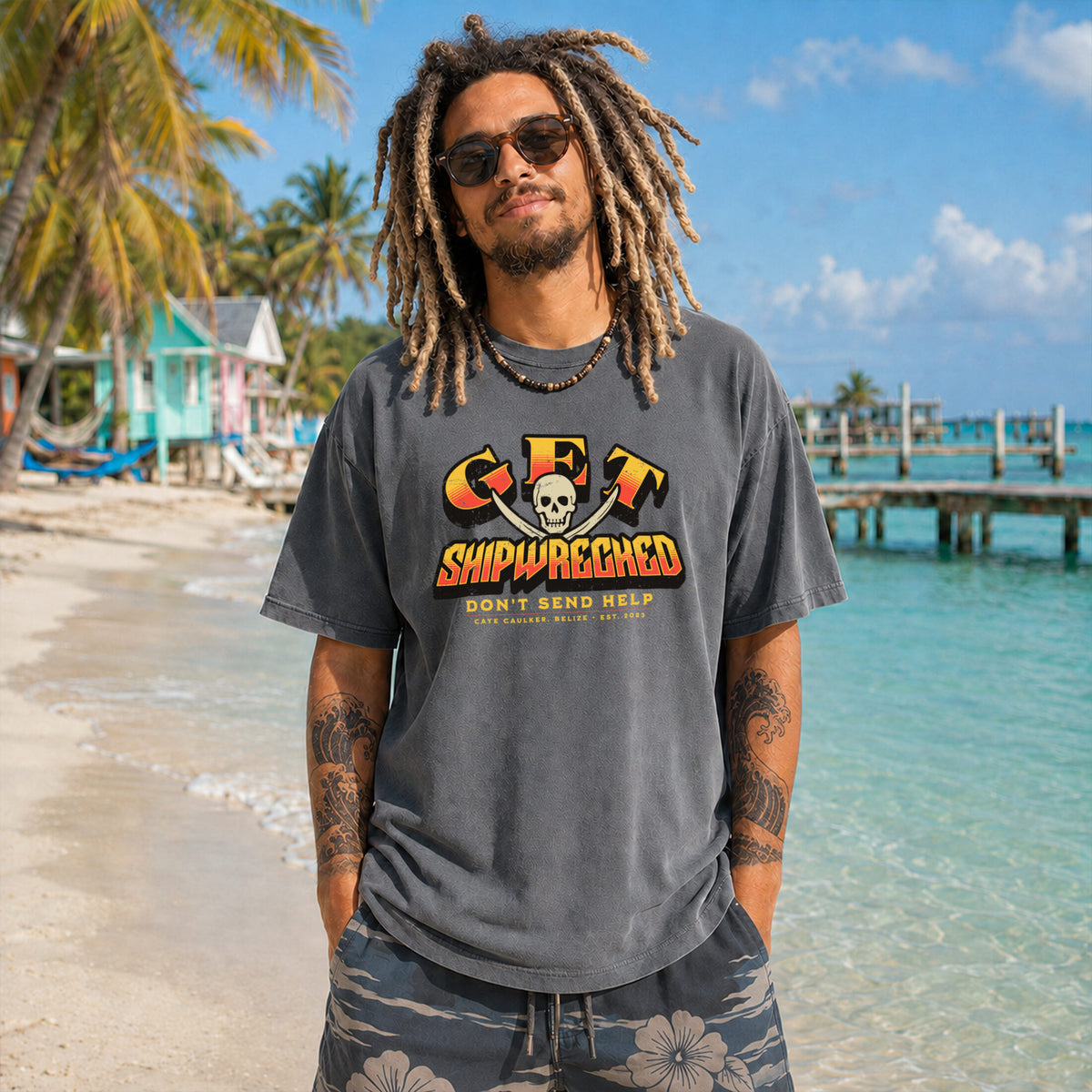 Model wearing the pepper Get Shipwrecked Rocker Tee with a Caye Caulker pirate graphic